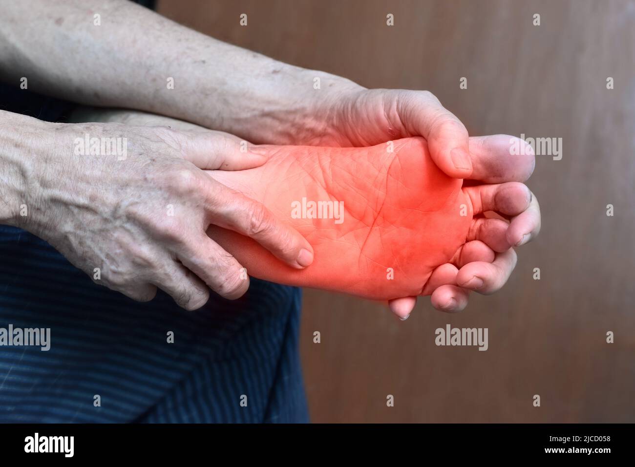 Tingling and burning sensation in foot of Asian old man with diabetes. Foot pain. Sensory neuropathy problems. Foot nerves problems. Plantar fasciitis Stock Photo