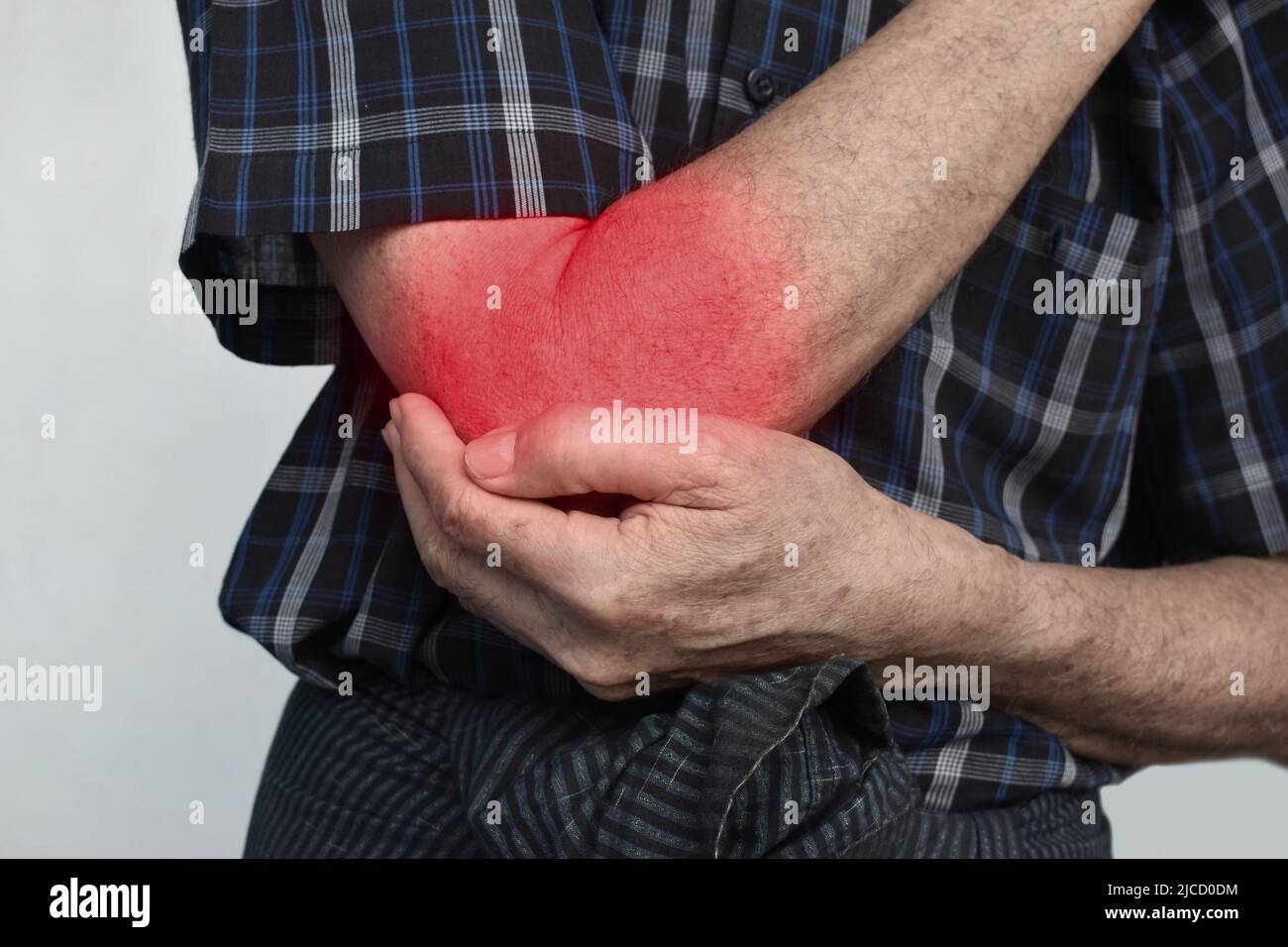 Pain in the elbow joint of Southeast Asian elder man. Concept of elbow