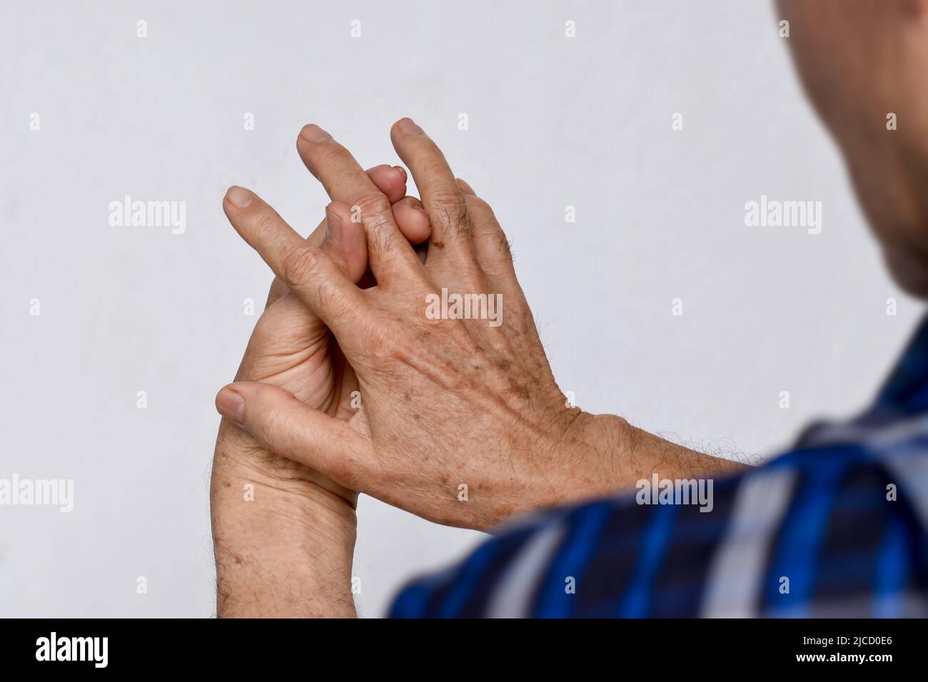 Inflammation of Asian old man middle finger and hand. Concept of arthritis and finger problem. Stock Photo