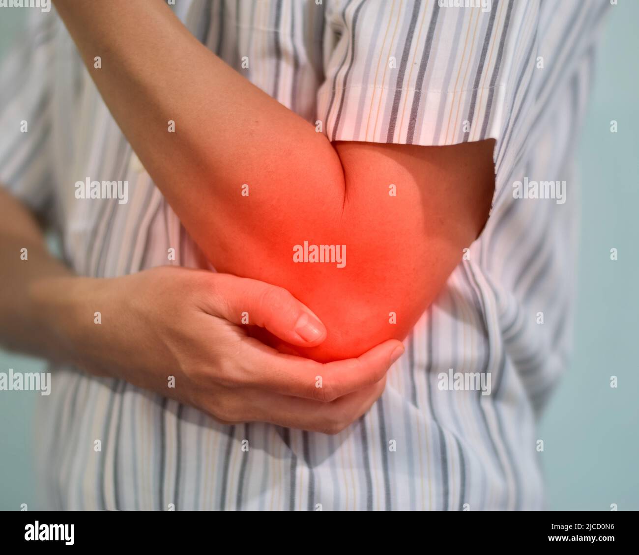 Pain in the elbow joint of Southeast Asian young man. Concept of elbow