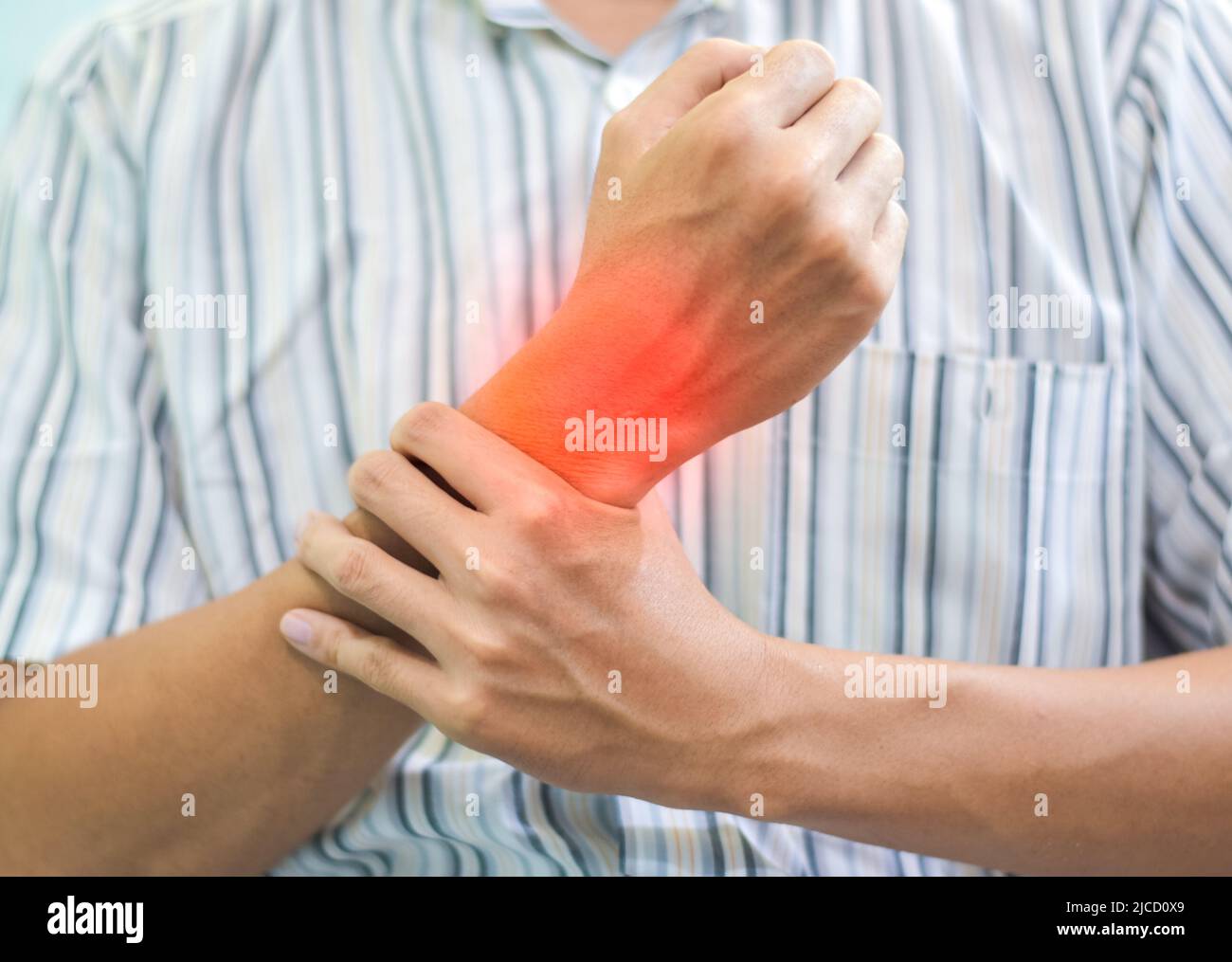 Inflammation of Asian young man wrist joint. Concept of joint pain and hand problems Stock Photo