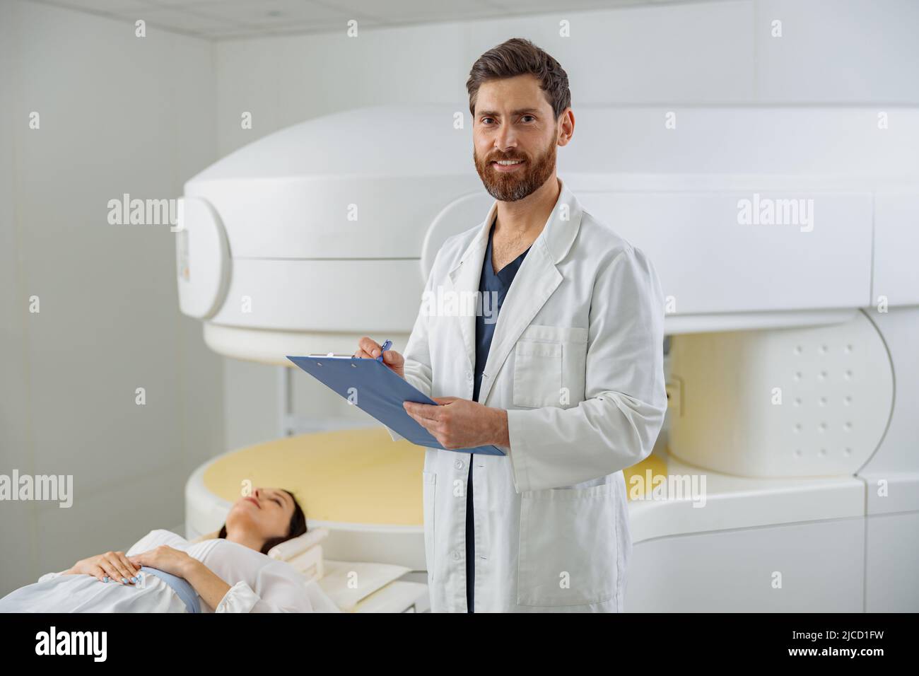 Radiologist controls MRI or CT or PET Scan with female patient