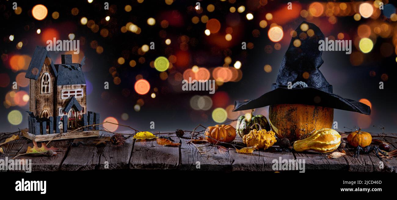Halloween background with pumpkins, candles on wooden table and bokeh Stock Photo