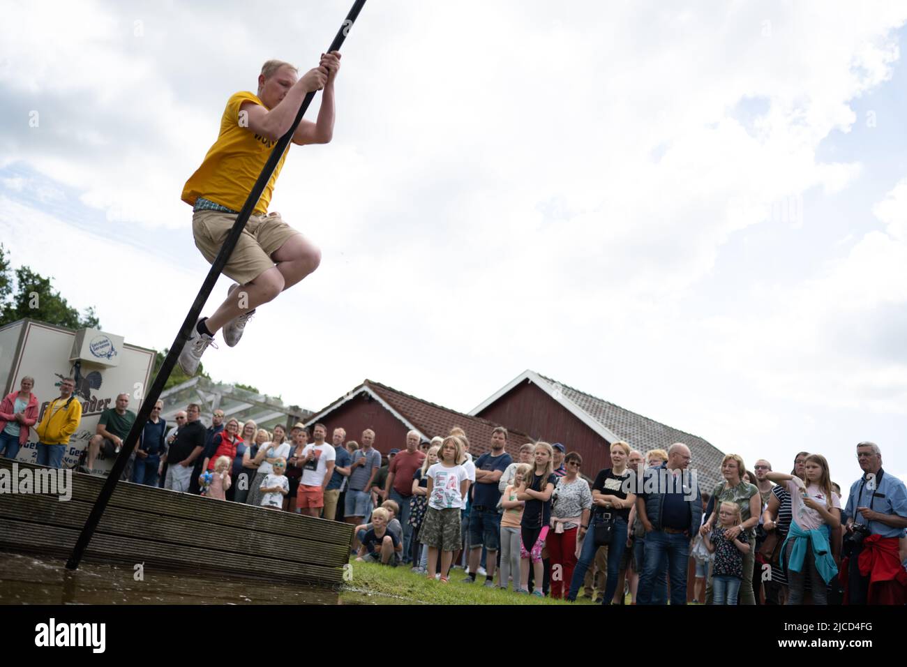 Bunde, Germany. 12th June, 2022. East Frisian Pullstock World Championship,  a participant jumps on the recreational area Ditzumerverlaat. Pullstock  jumping is the term used for pole long jumping over watercourses. Credit:  Lars