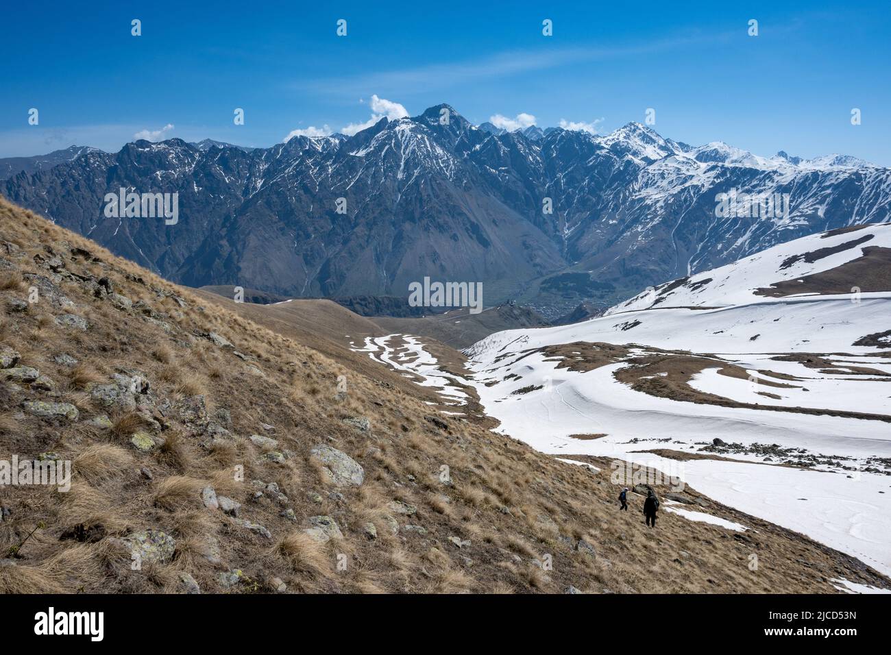 Hikers on the trail of Mount Kazbeg. Caucasus Mountains. Stepantsminda, the Republic of Georgia. Stock Photo