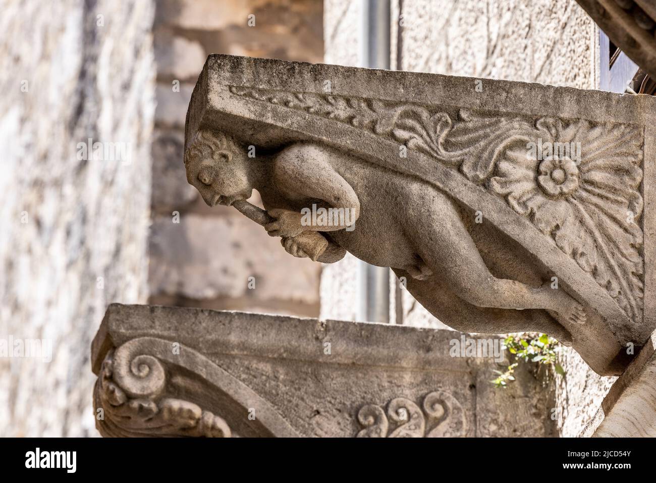 Carved Stone Corbel with Flutist, Korcula, Croatia Stock Photo