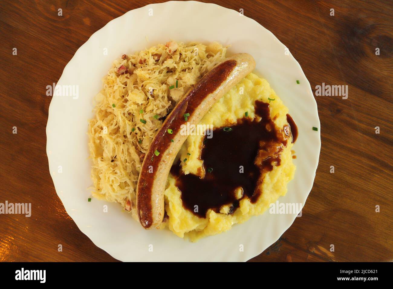 mashed potatoes with sausage and pickled cabbage Stock Photo