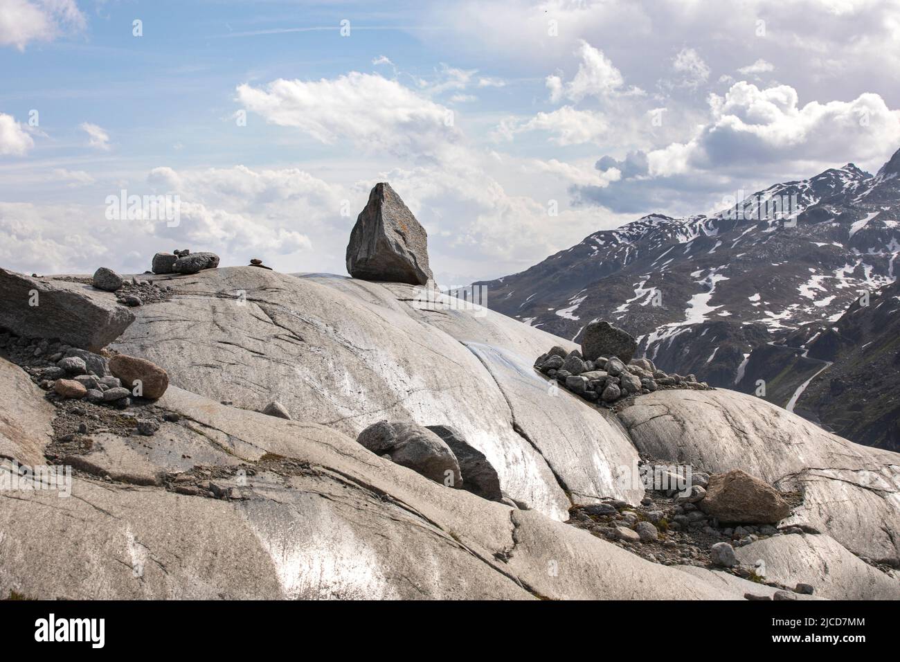 Minimal landscape in alps mountains. Arid terrain in high mountains, stone stand on the rocky mountainside. Beautiful nature on top of a mountain. Stock Photo