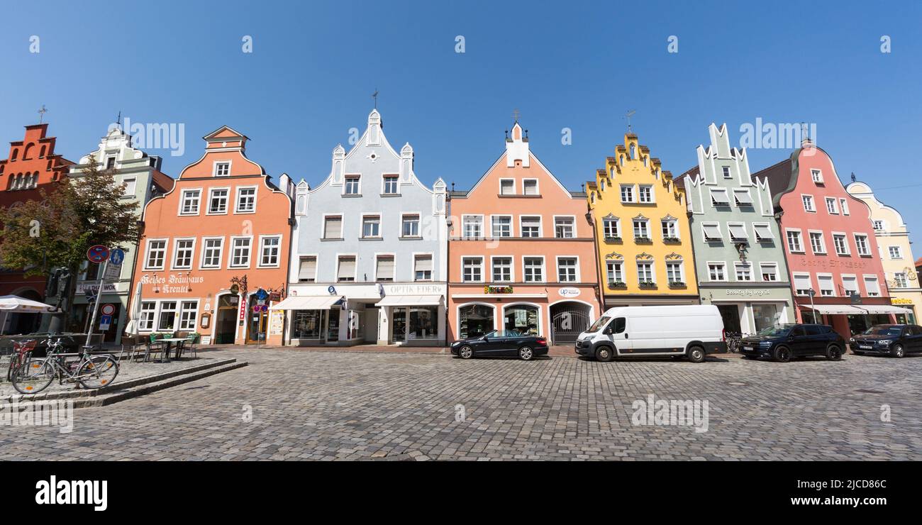 Landshut, Germany - Aug 15, 2021: Historical houses with colorful facades in the old town of Landshut. Panorama format, blue sky. Stock Photo