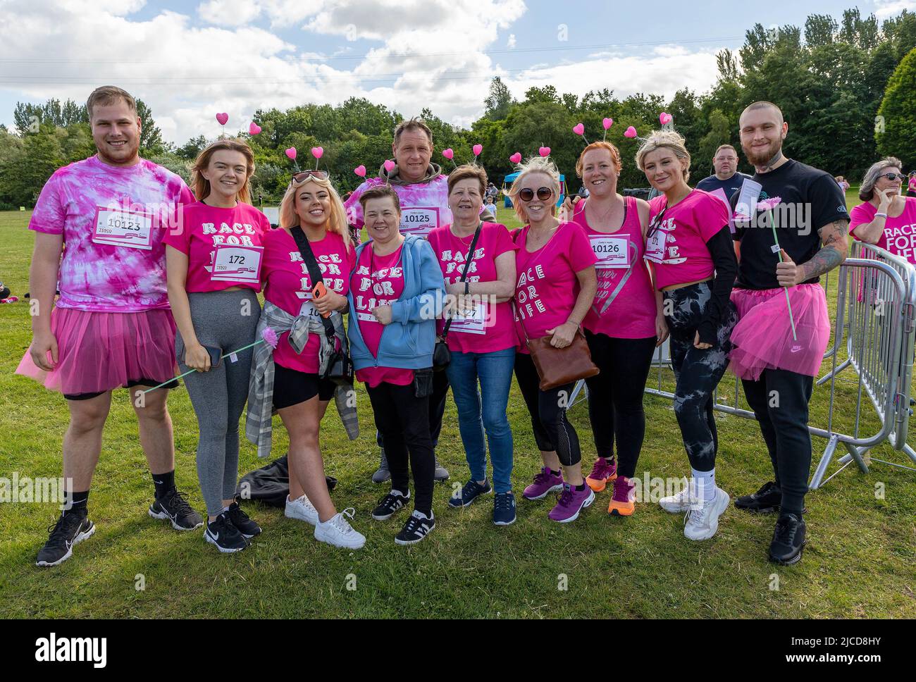 12 June 2022; Warrington Cheshire, UK; Race for Life in Victoria Park in aid of Cancer Research. Runners pose for a photo before the run Credit: John Hopkins/Alamy Live News Stock Photo
