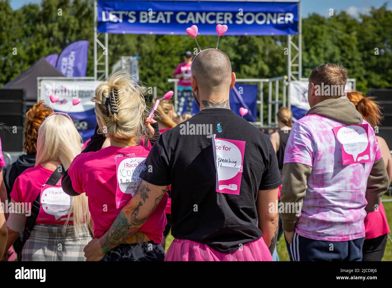 12 June 2022; Warrington Cheshire, UK; Race for Life in Victoria Park in aid of Cancer Research. The runners listen to instructions Credit: John Hopkins/Alamy Live News Stock Photo