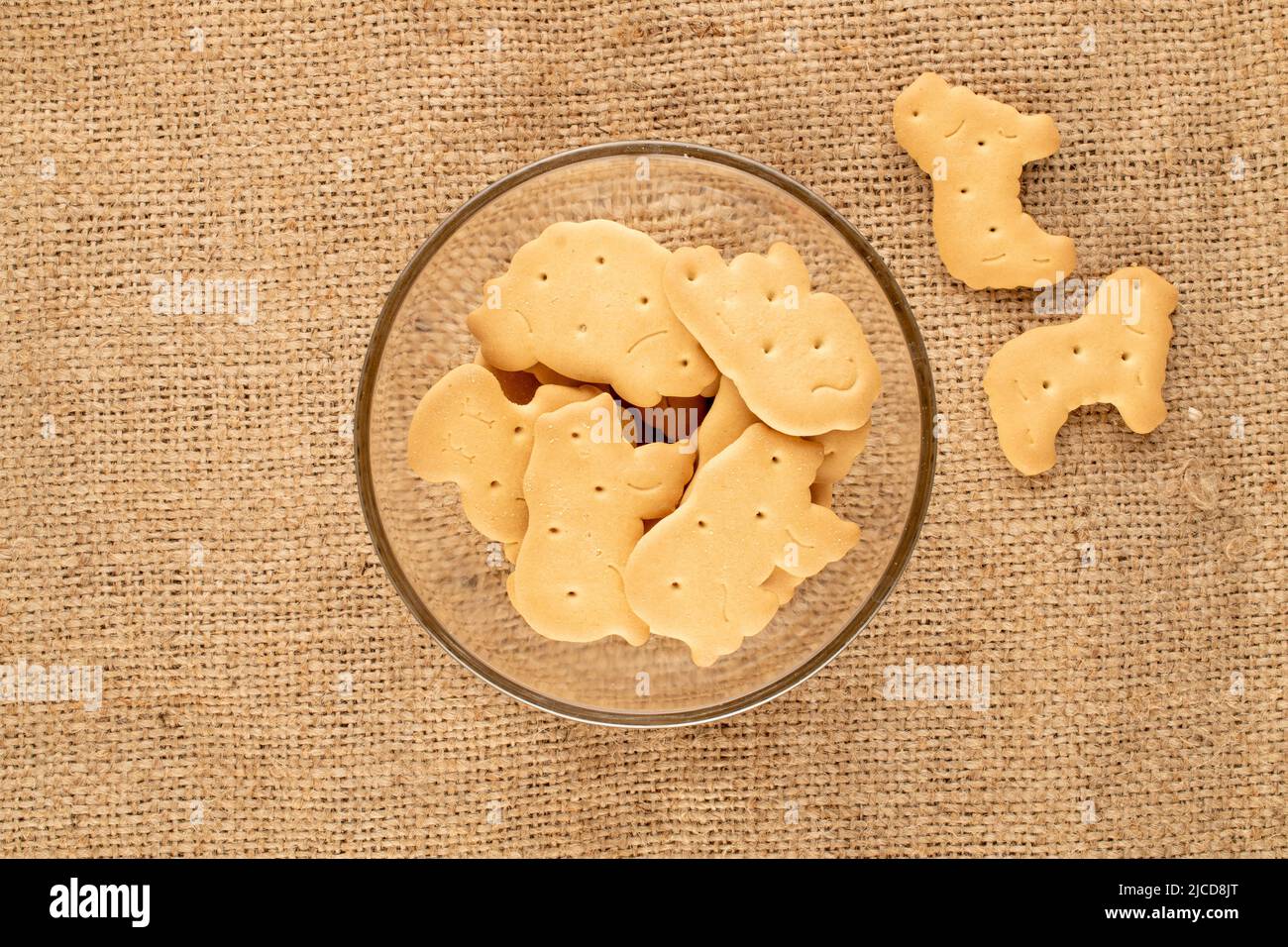Several homemade  cookies in glassware on jute fabric, close-up, top view. Stock Photo