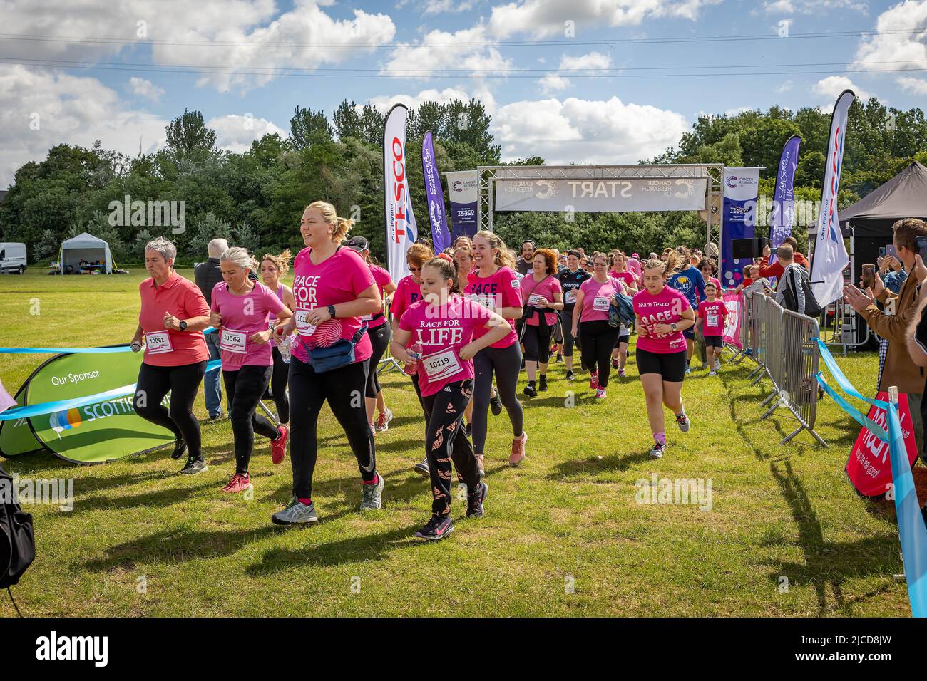 12 June 2022; Warrington Cheshire, UK; Race for Life in Victoria Park in aid of Cancer Research. The runners start the race Credit: John Hopkins/Alamy Live News Stock Photo
