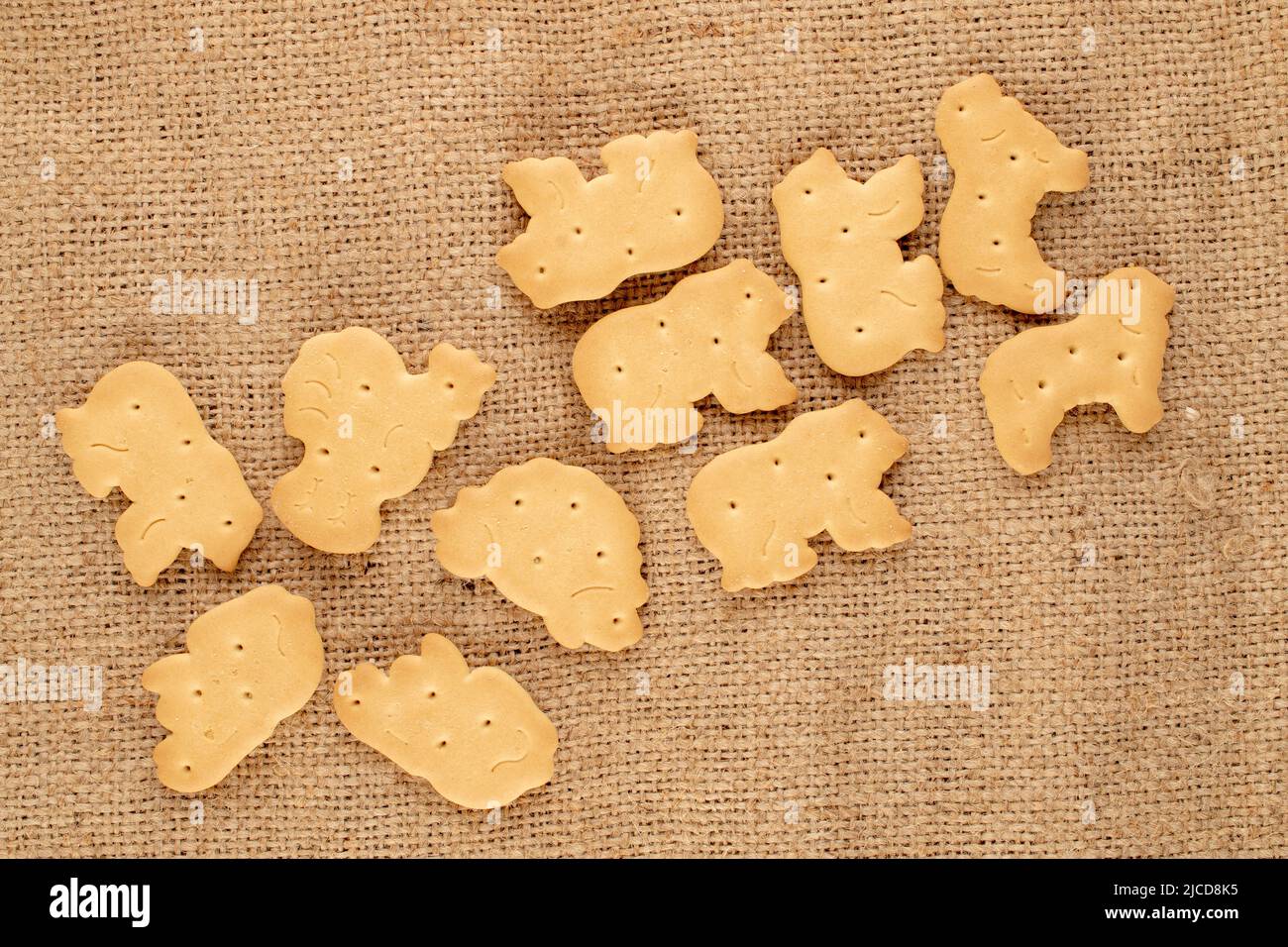 Several homemade cookies on jute fabric, close-up, top view. Stock Photo