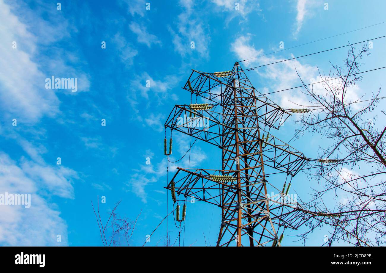 High voltage electric power lines on pylons in blue sky Stock Photo - Alamy