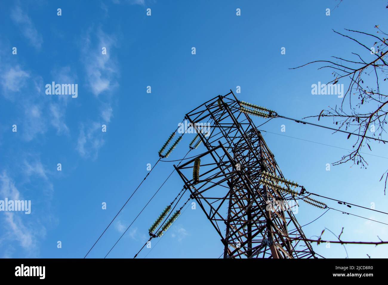 High voltage electric power lines on pylons in blue sky Stock Photo - Alamy