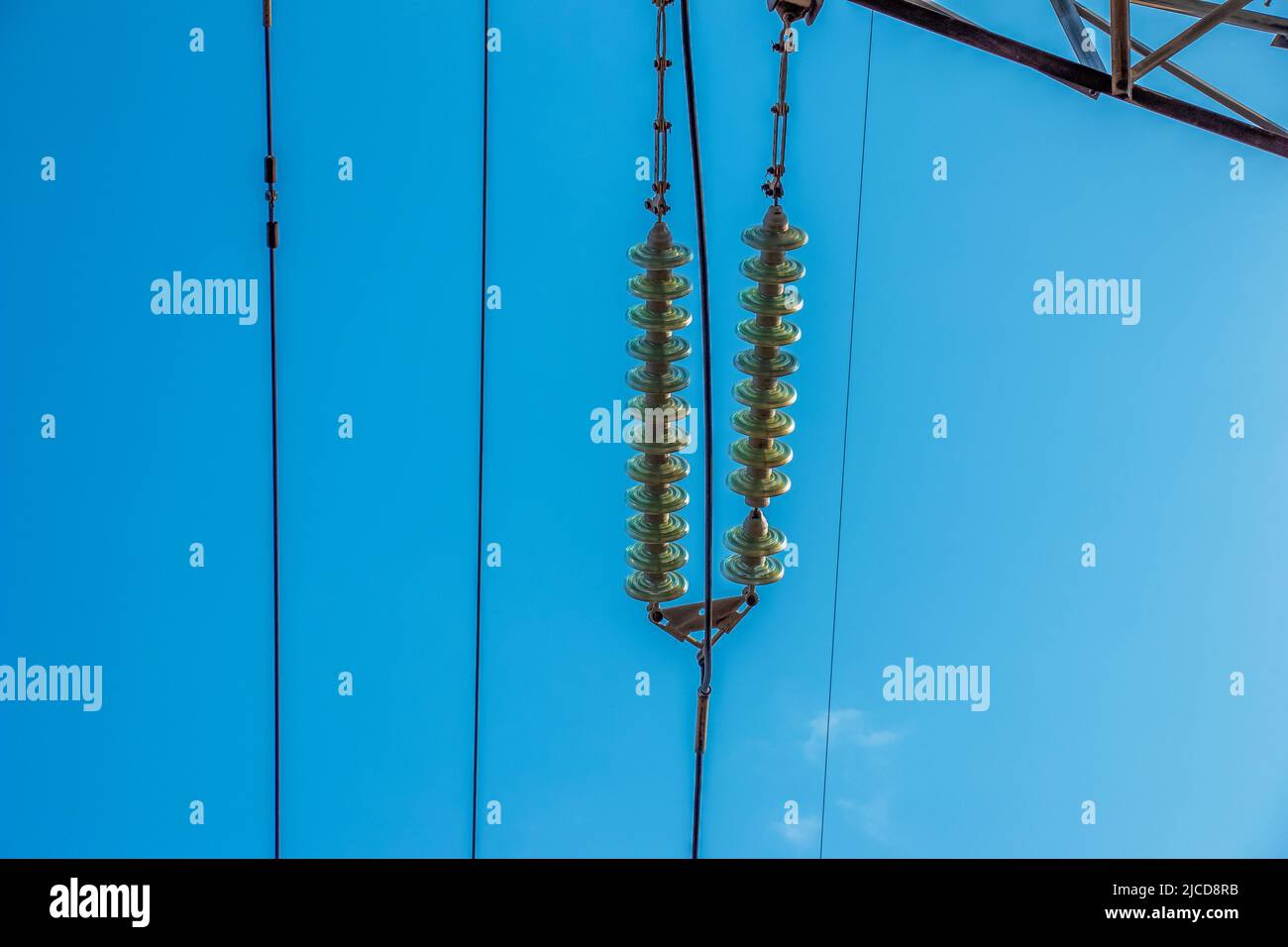 High voltage electric power lines on pylons in blue sky Stock Photo - Alamy