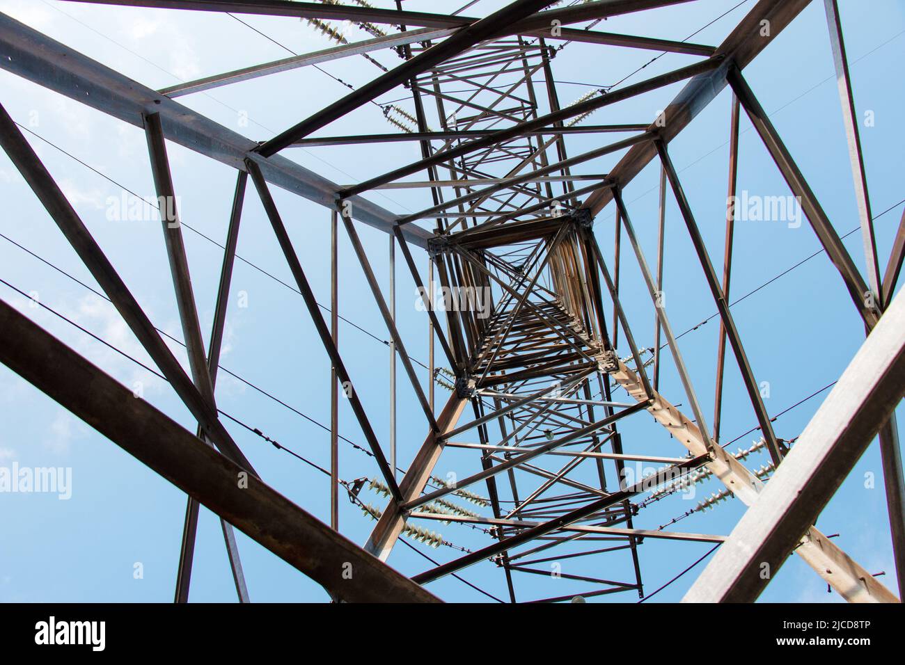 Closeup view of an electric tower with a beautiful blue sky background. Industrial engineering