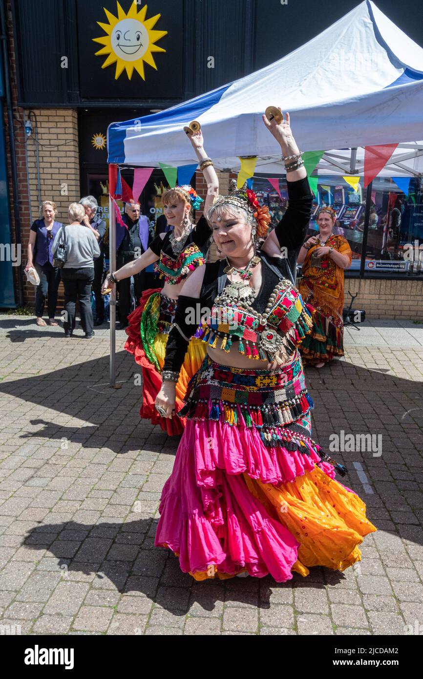 Belly dancers in colourful costumes performing at Victoria Day, an annual event in Aldershot town, Hampshire, England, UK Stock Photo