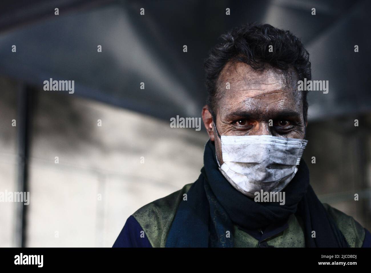 The tired face of a mine worker Stock Photo