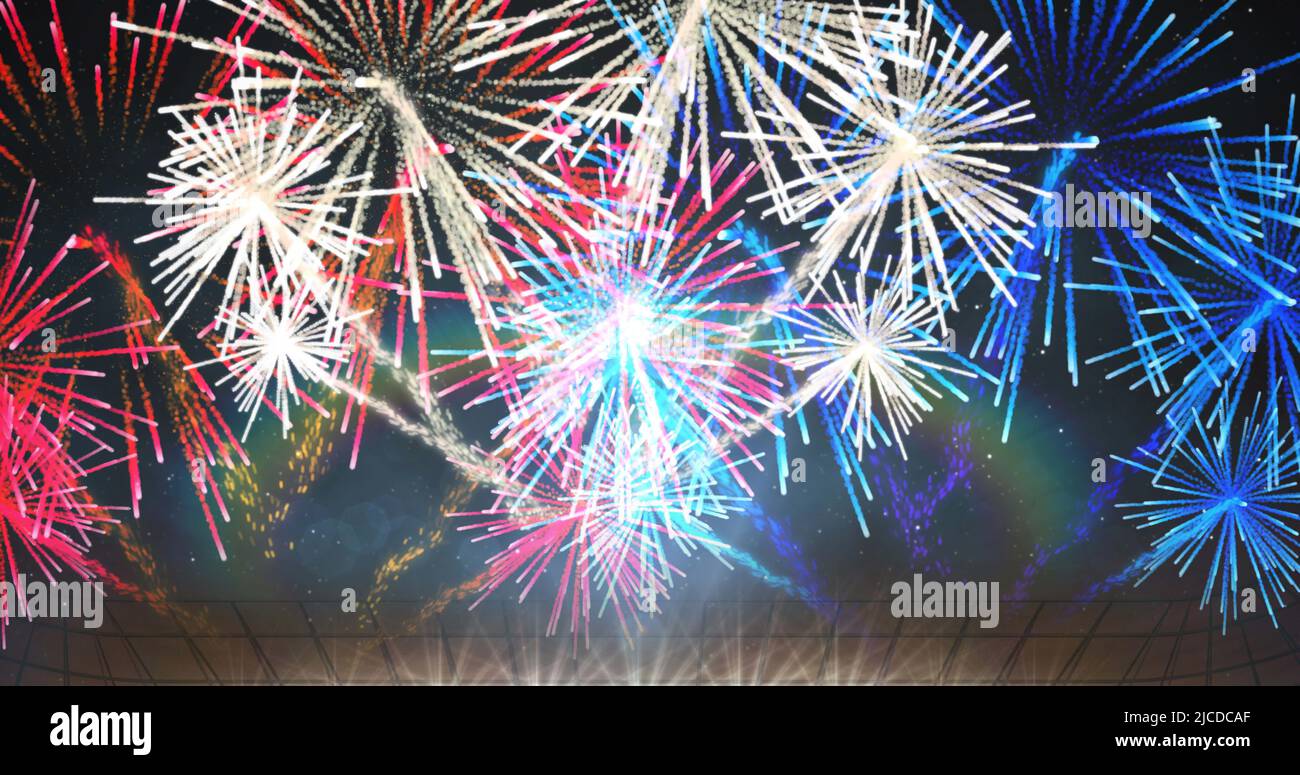 Image of exploding colourful fireworks and spotlights on black background Stock Photo
