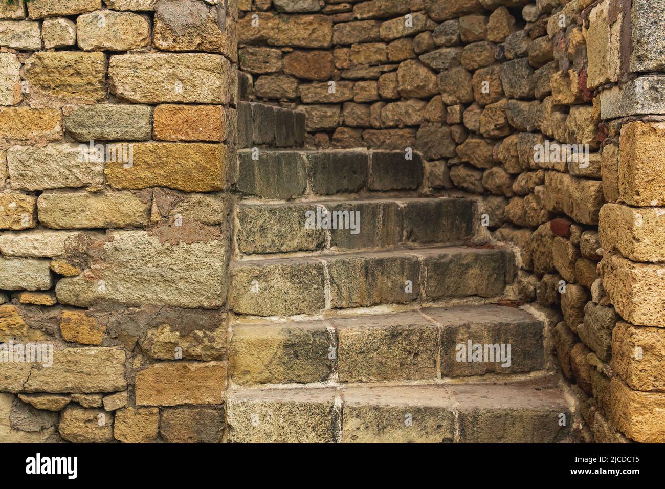 passage with a spiral staircase in an ancient stone wall Stock Photo ...