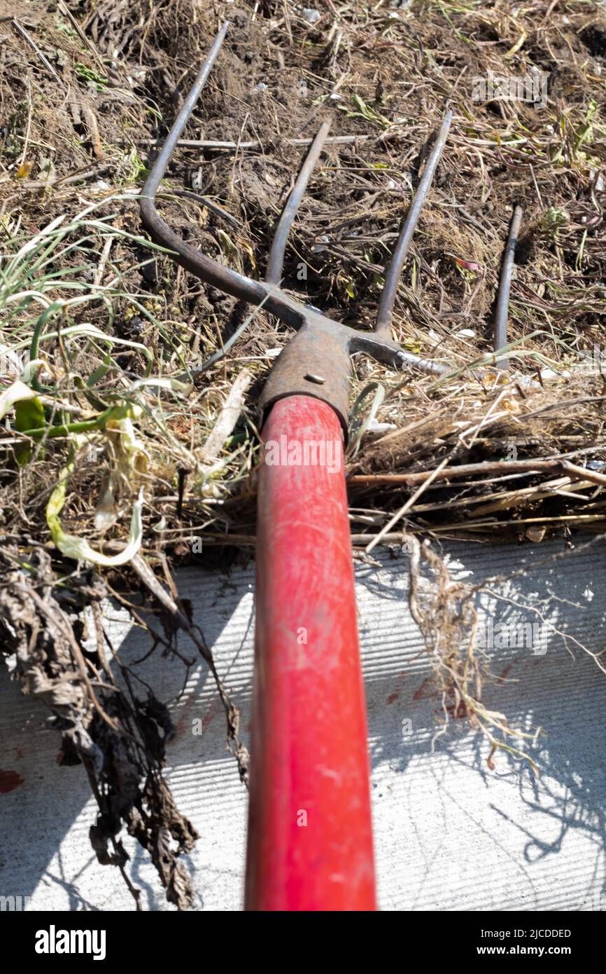 Fork with red handle for composting, recycling lawn and garden waste