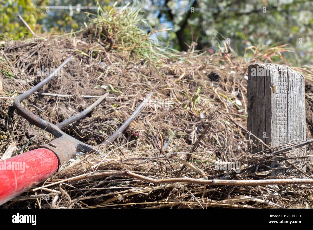 Fork with red handle for composting, recycling lawn and garden waste