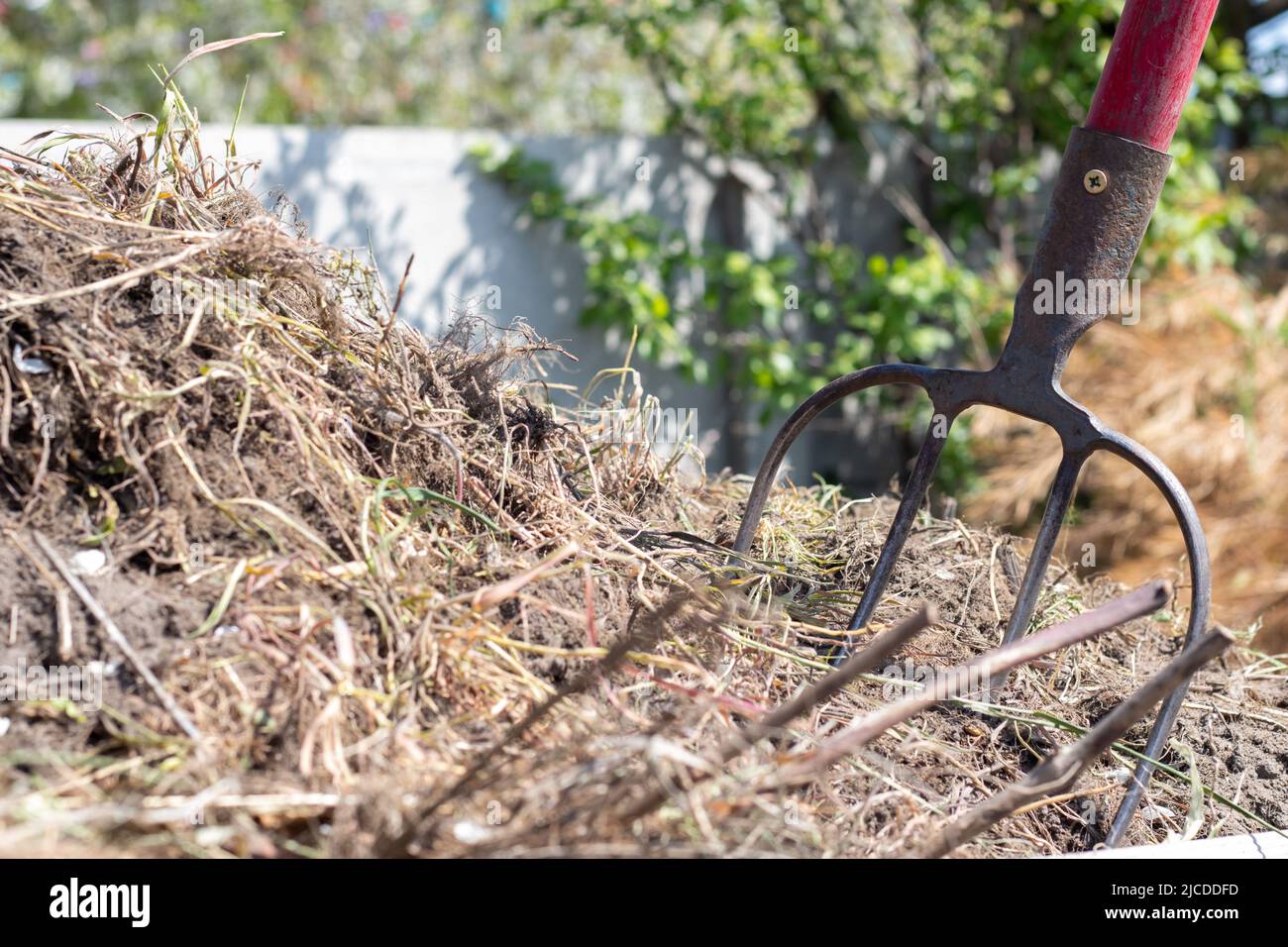 Fork with red handle for composting, recycling lawn and garden waste