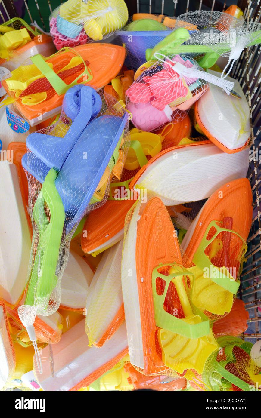 Colourful plastic beach toys in a bin outside a store in Sidney, British Columbia on Vancouver Island, Canada Stock Photo