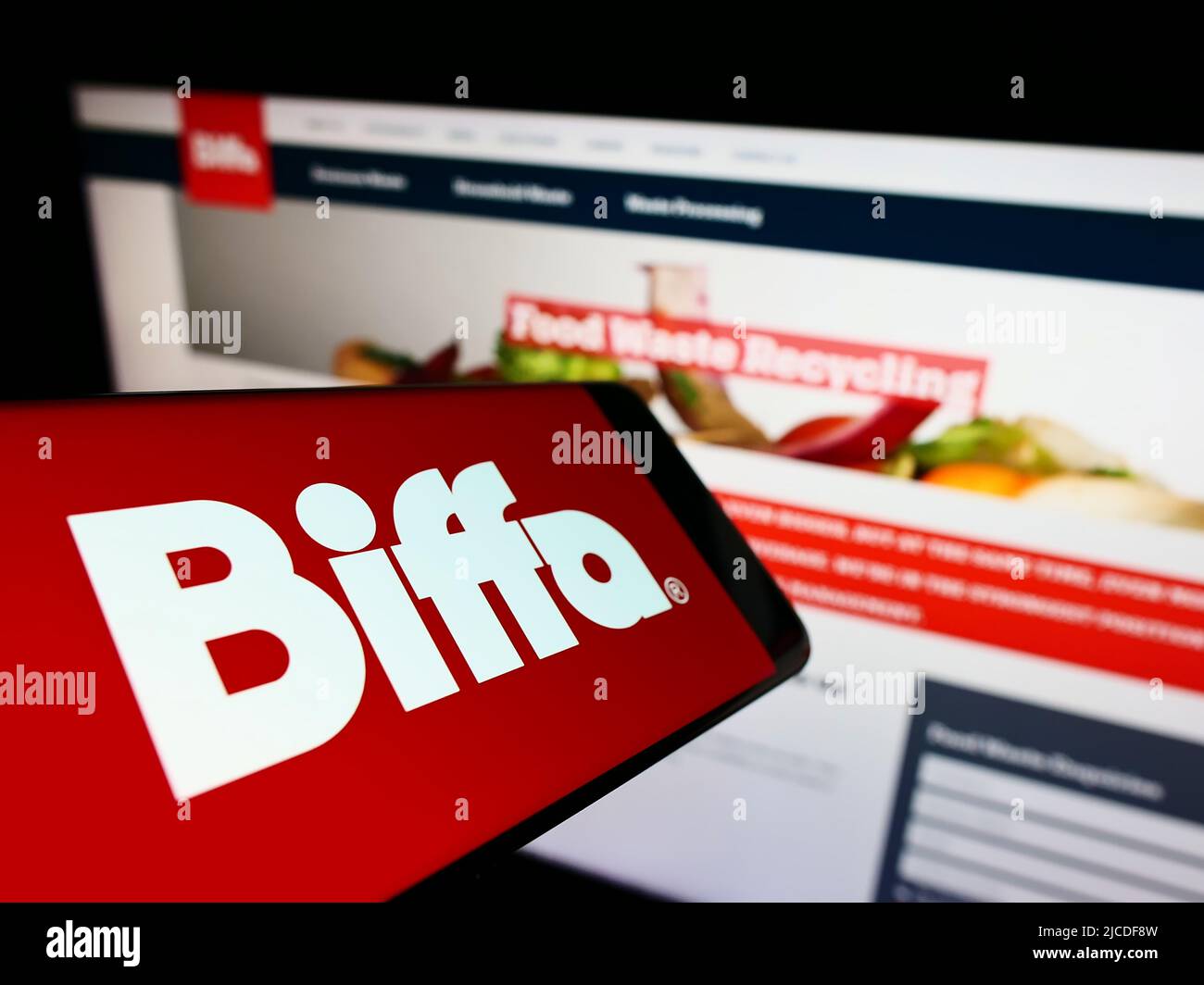 Cellphone with logo of British waste management company Biffa plc on screen in front of business website. Focus on center of phone display. Stock Photo
