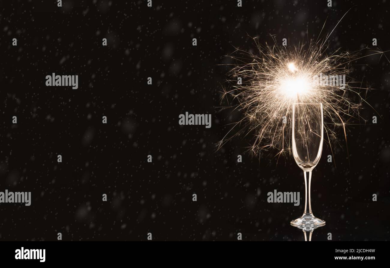 Glass with a sparkler. In anticipation of New Year and Christmas Stock Photo