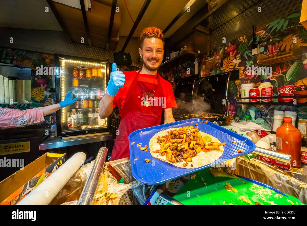The owner of Burrito Express, Manchester preparing a Burrito full of