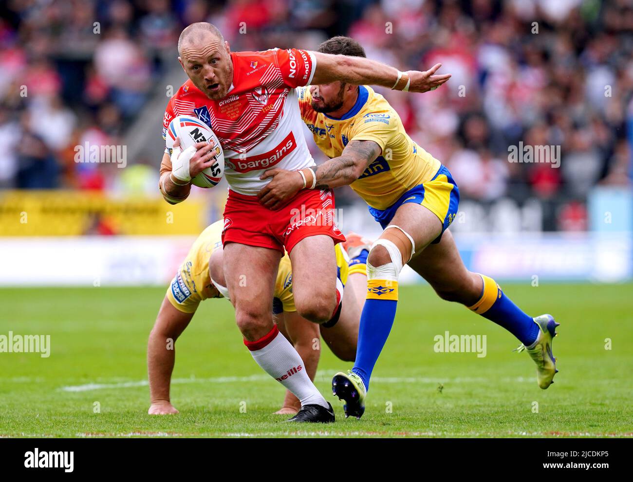 St Helens' James Roby is tackled by Hull Kingston Rovers' George King ...