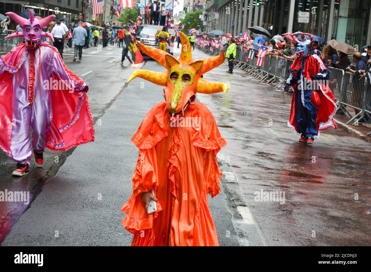 Participants  are seen  wearing traditional costume on Fifth Avenue in New York City during the National Puerto Rican Day Parade, returning after a tw Stock Photo