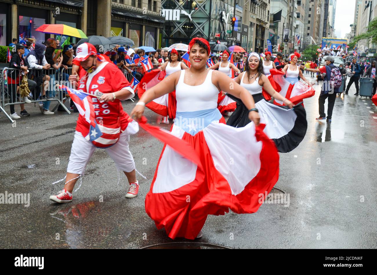 Girls are seen dancing with traditional Puerotican outfits during the