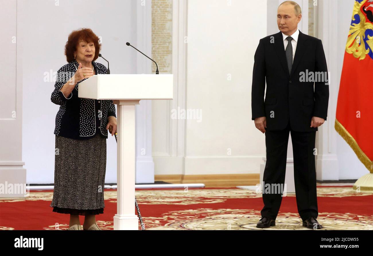 Moscow, Russia. 12th June, 2022. Russian President Vladimir Putin looks on as Irina Krasnopolskaya, a journalist with Rossiyskaya Gazeta speaks, after being awarded the “Hero of Labor” to celebrate Russia Day at Saint Georges Hall in the Grand Kremlin Palace June 12, 2022 in Moscow, Russia. Credit: Mikhail Metzel/Kremlin Pool/Alamy Live News Stock Photo