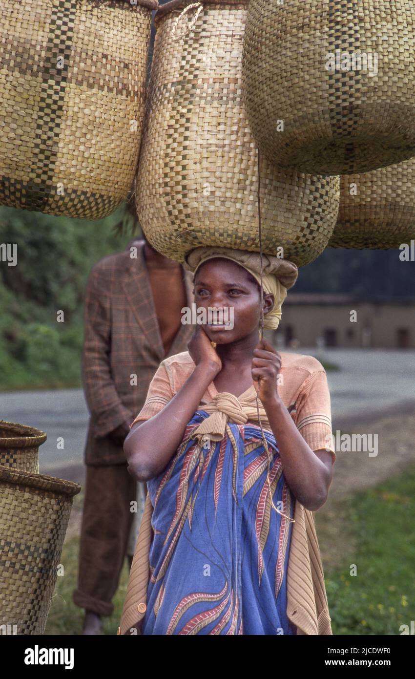 Woman basket maker on way to market to sell her wares. Stock Photo