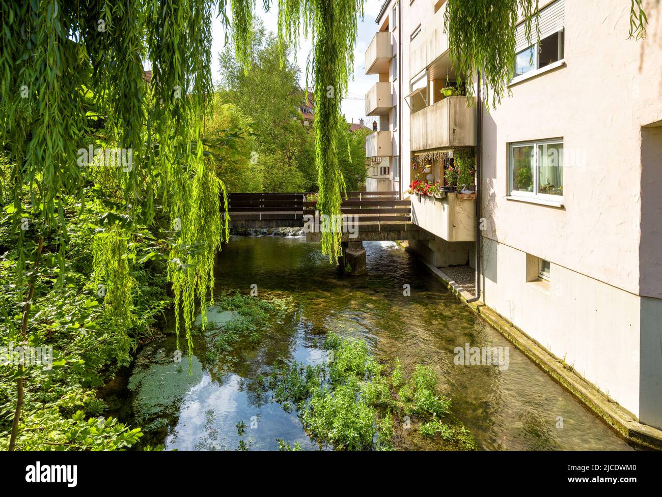 House in town of Ulm, Baden-Wurttemberg, Germany. Scenic view of residential building by water canal in summer. Historical Fisherman Quarter in Ulm ci Stock Photo