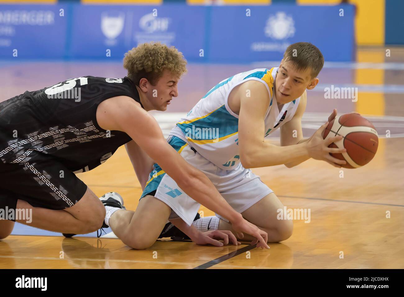Doha, Qatar. 12th June, 2022. Kalid Petzer (L) of New Zealand Basketball  team and Yegor Samoilov of Kazakhstan Basketball team in action during the  2022 FIBA U16 Asian Championship match between New