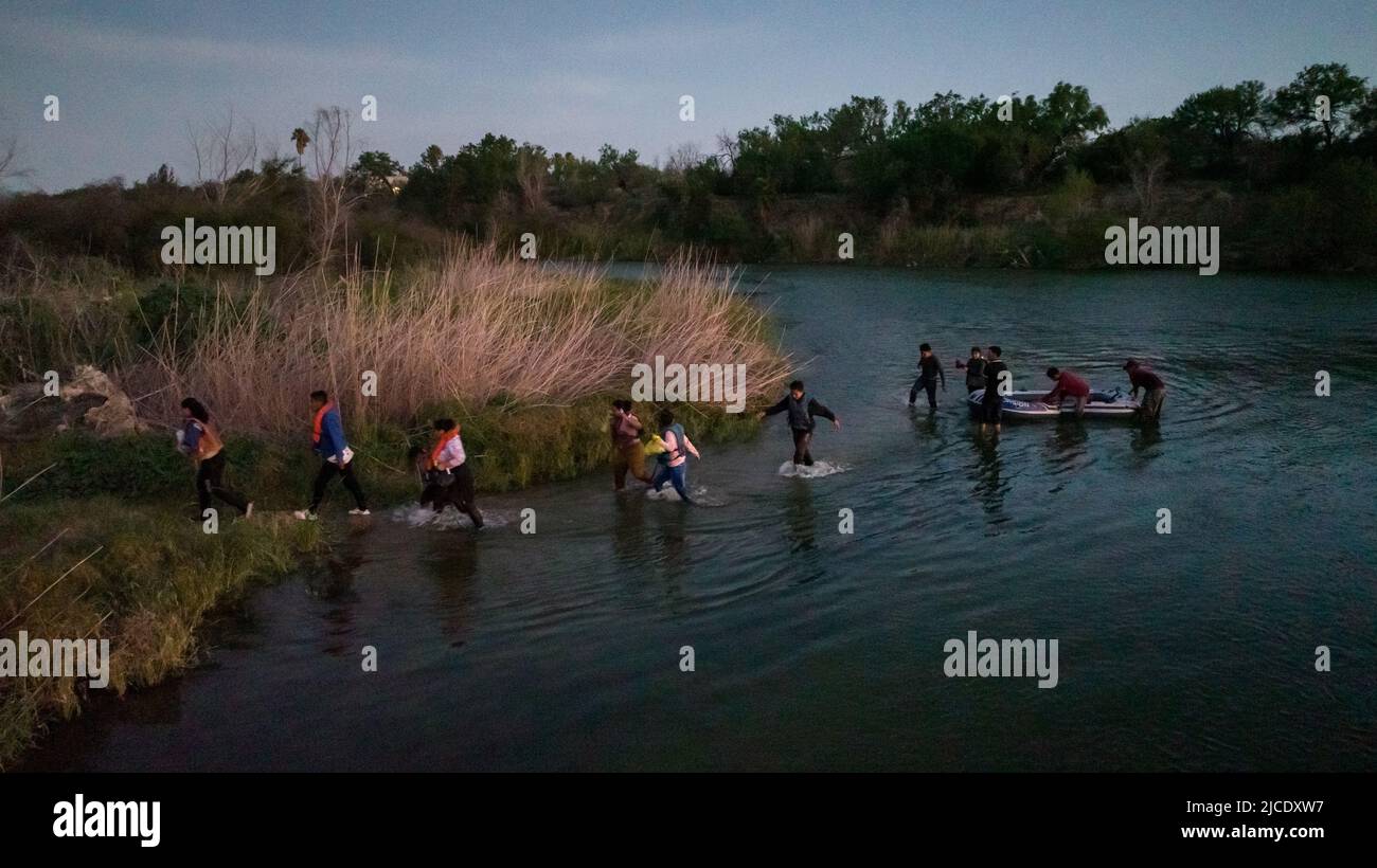 Asylum seeking migrants from Central and South America exit their raft onto an island in the middle of Rio Grande river as they prepare to be smuggled into United States from Mexico in Roma, Texas, U.S., June 11, 2022. Picture taken with a drone on June 11, 2022. REUTERS/Adrees Latif     TPX IMAGES OF THE DAY Stock Photo