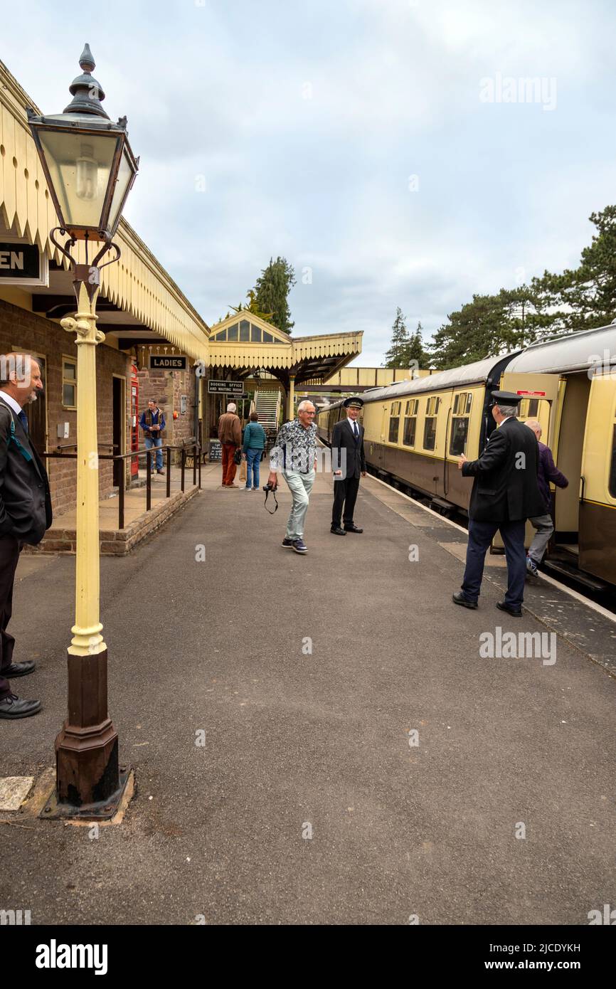 Tourists and voluntary staff of the Gloucestershire Warwickshire Steam Railway on the platform of Winchcombe Station, Gloucestershire, England, UK. Stock Photo