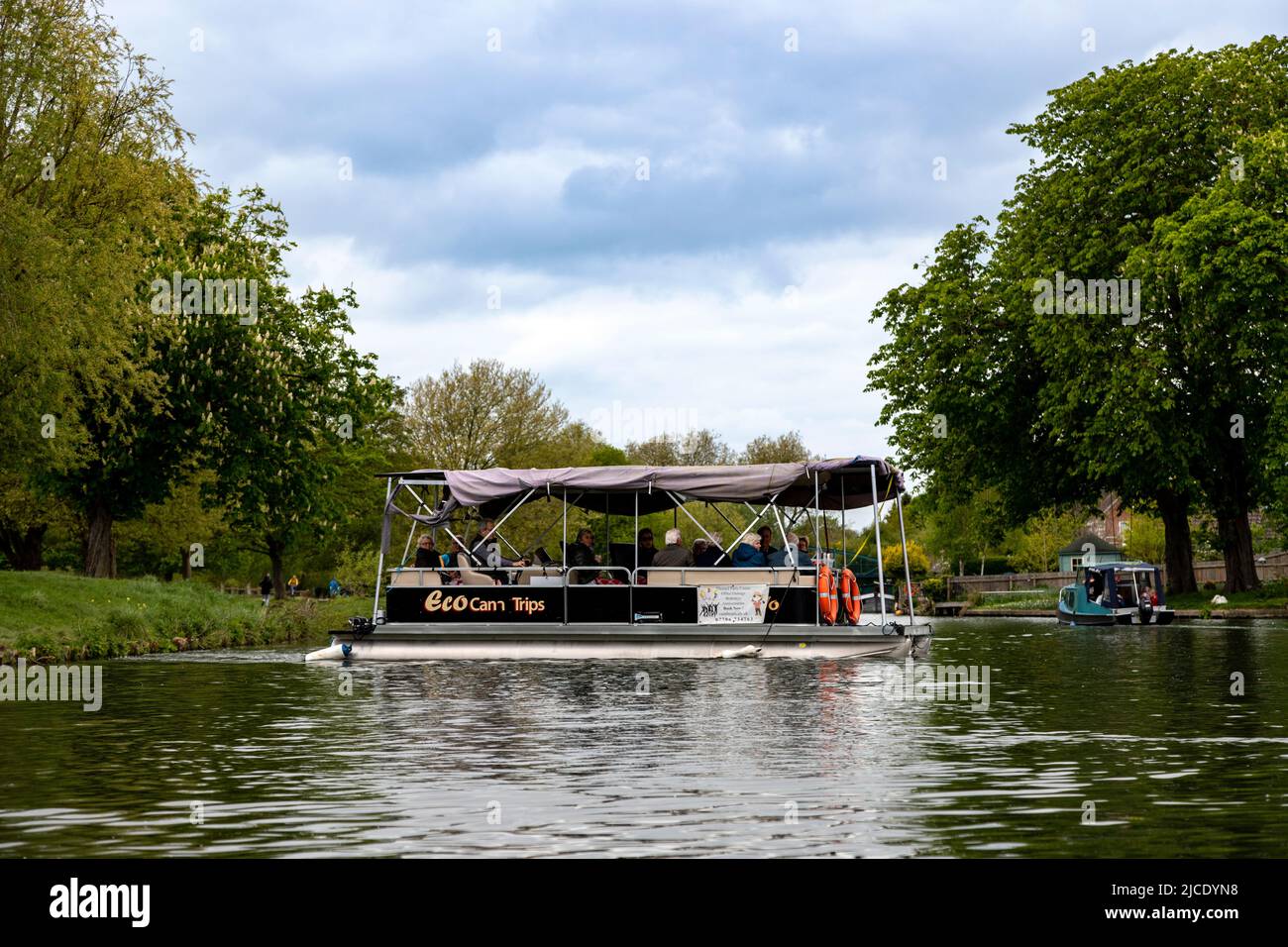Sightseeing tourists aboard an ECO CAM TRIP pleasure boat, cruising on River Cam at Stourbridge Common, Cambridge, Cambridgeshire, England, UK. Stock Photo