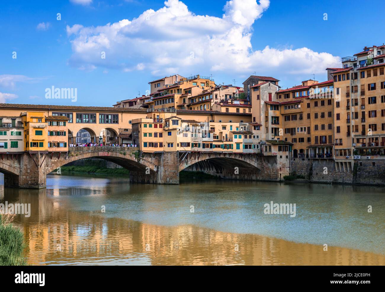 Ponte Vecchio (old Bridge) in Florence, Tuscany, Italy. A medieval stone bridge that spans river Arno and has always hosted shops and merchants. Stock Photo