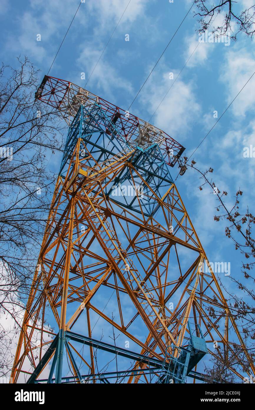High voltage electric power lines on pylons in blue sky Stock Photo - Alamy