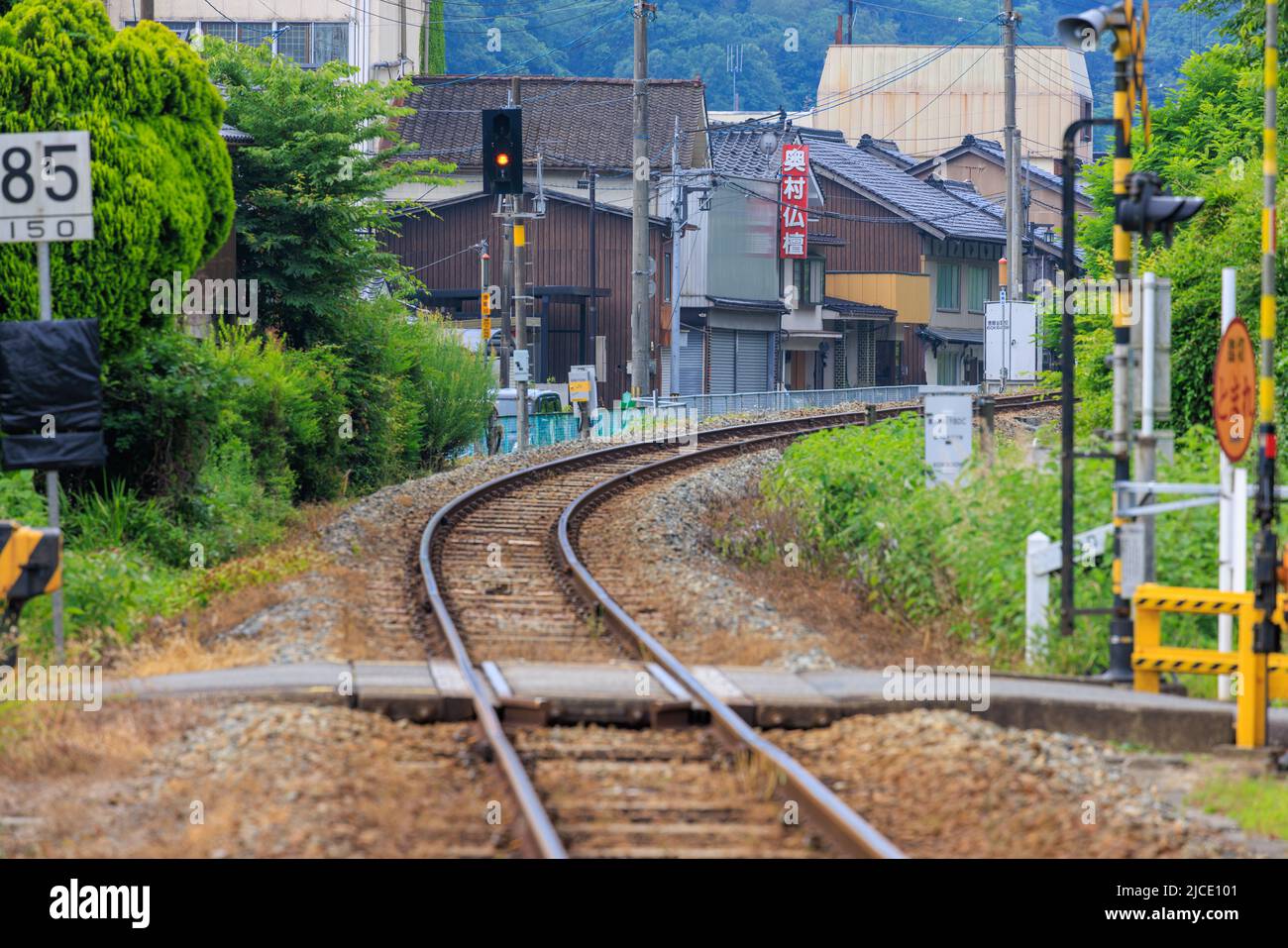 Train tracks curve into small Japanese town Stock Photo