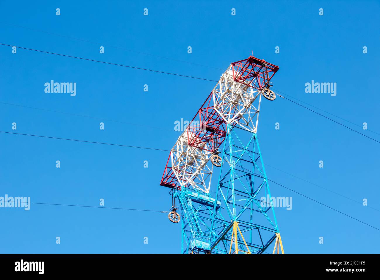 High voltage electric power lines on pylons in blue sky Stock Photo - Alamy