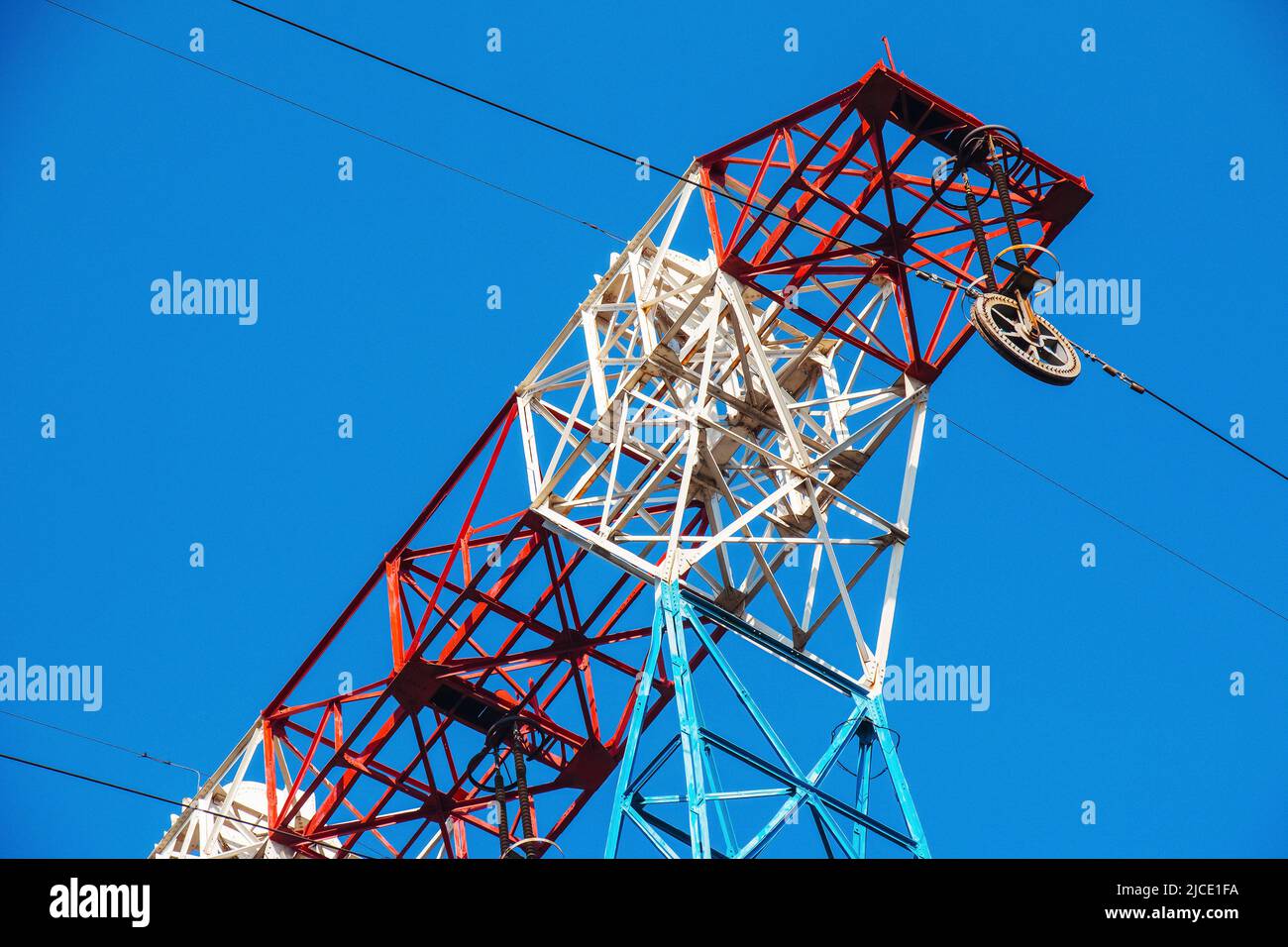 High voltage electric power lines on pylons in blue sky Stock Photo - Alamy