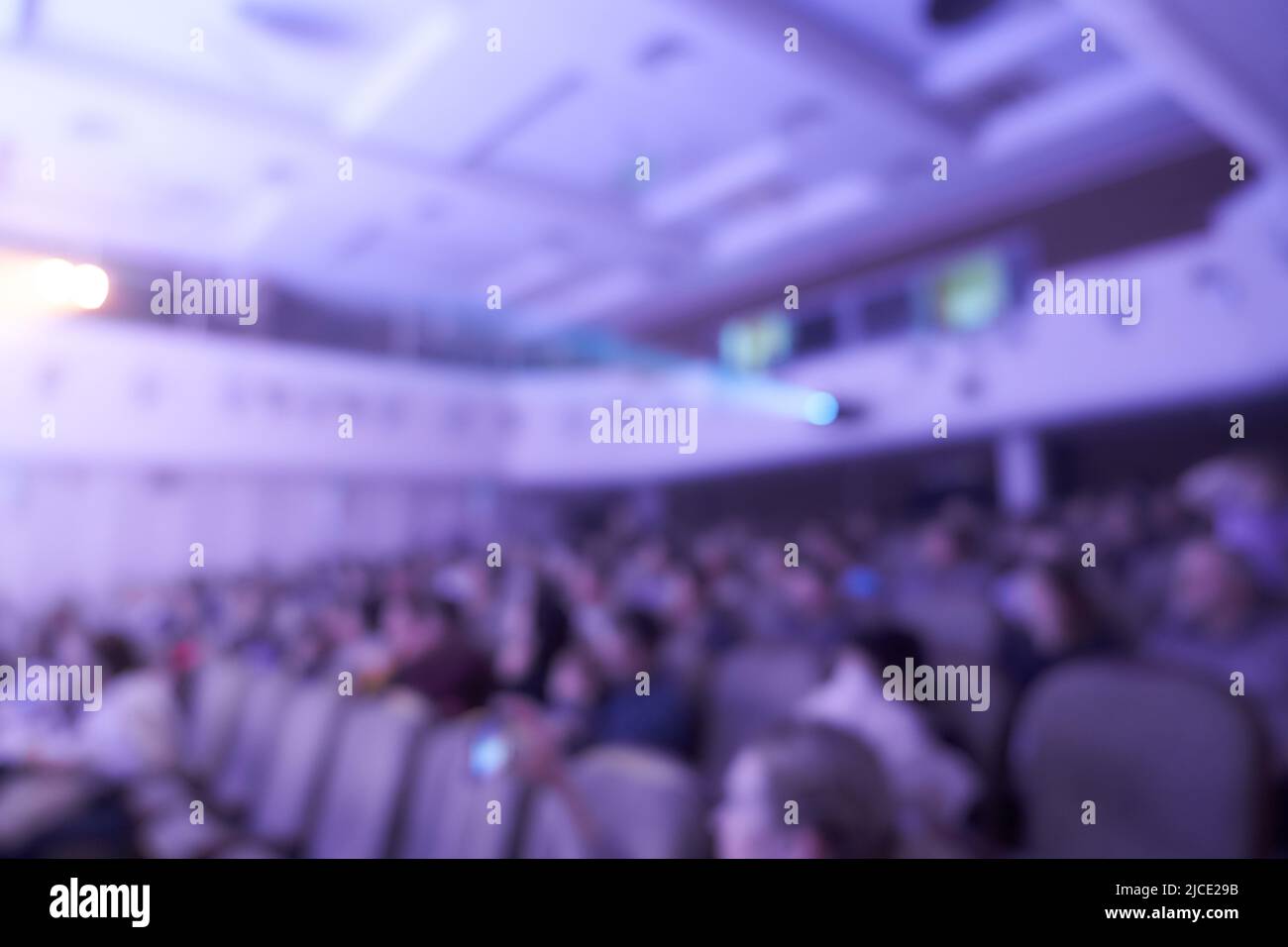 Event hall with chairs on a blurry background. The audience of a music concert hall or a