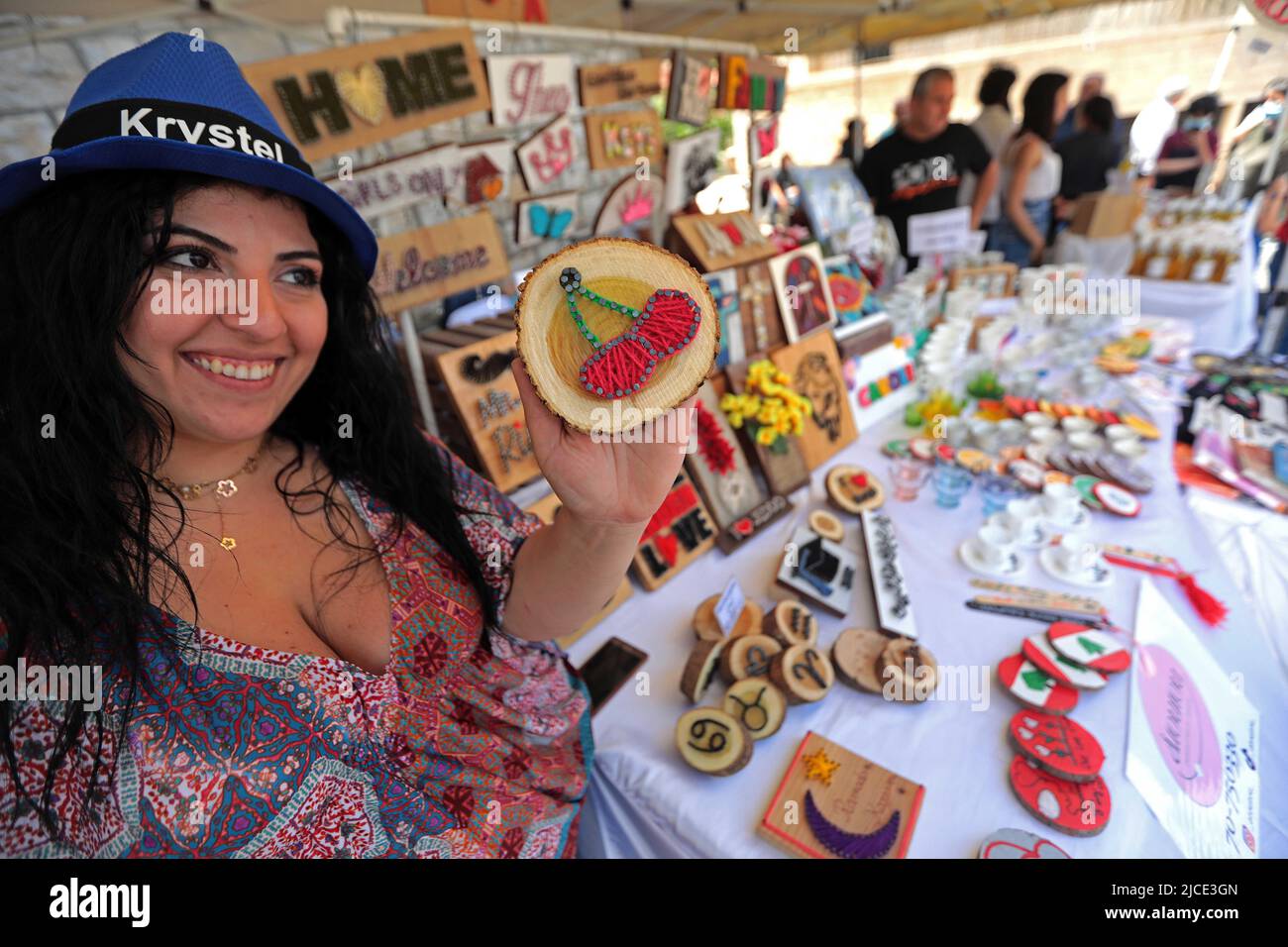 Hammana, Lebanon. 12th June, 2022. A woman shows a handcraft with cherry design at the Hammana